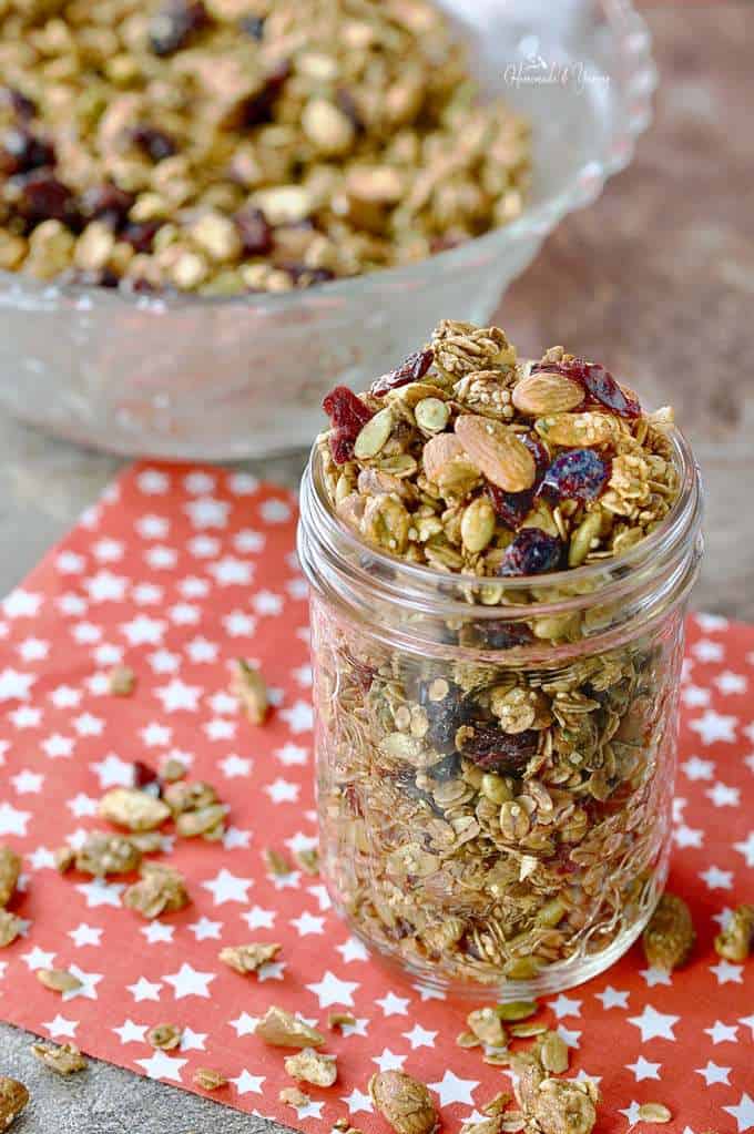 Jar of granola with almonds, cranberries, pumpkins seeds and oats.
