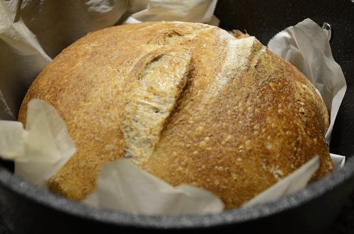 Crusty loaf of sourdough bread golden brown.
