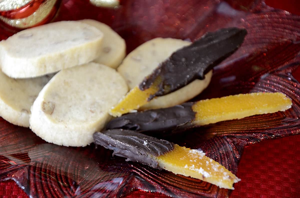 Pecan shortbread and chocolate dipped candied orange peel on a Christmas cookie plate.