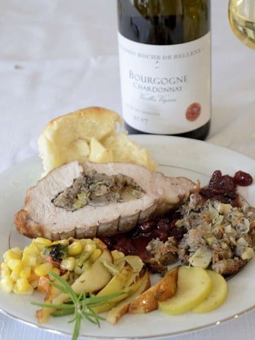 Plate with Stuffed pork loin roast, port cranberry sauce, Fall corn salad and broiled apples and pears.