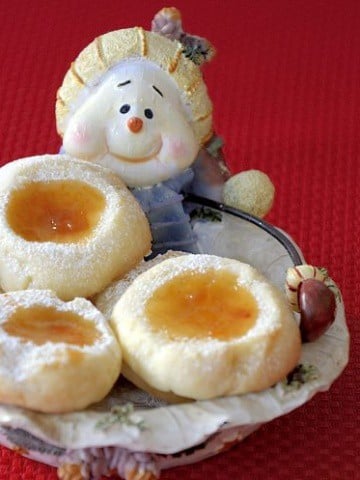apricot filled thumbprint cookies in a snowman christmas plate.