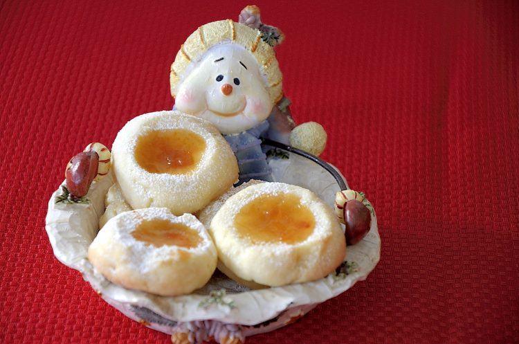 apricot filled thumbprint cookies in a snowman christmas plate.