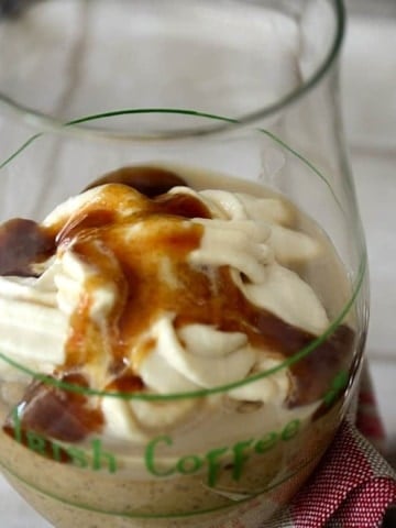 Irish coffee glass filled with mocha, caramel mousse topped with Bailey's whipped cream and caramel sauce.