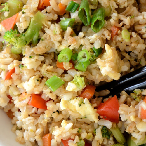 Close up of fried rice superfood with green onions and red pepper.