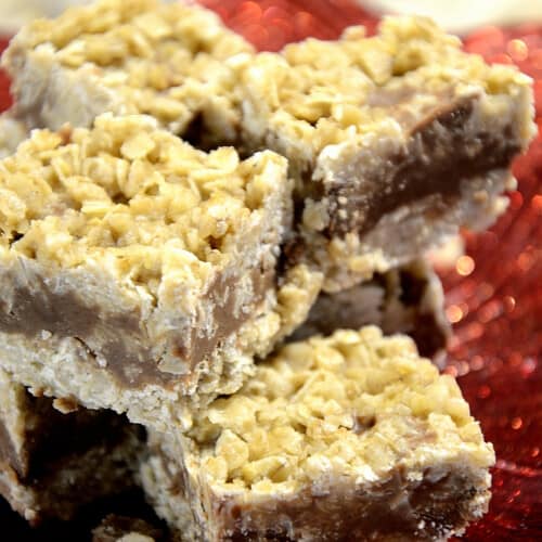 Oat squares with chocolate, peanut butter center piled on a small plate.
