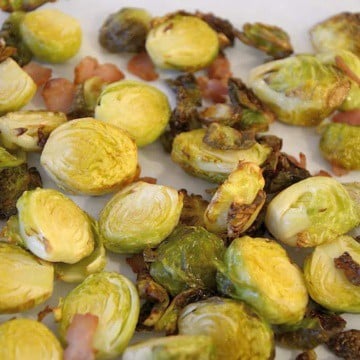 Roasted Brussel sprouts cut in half with bacon bits.