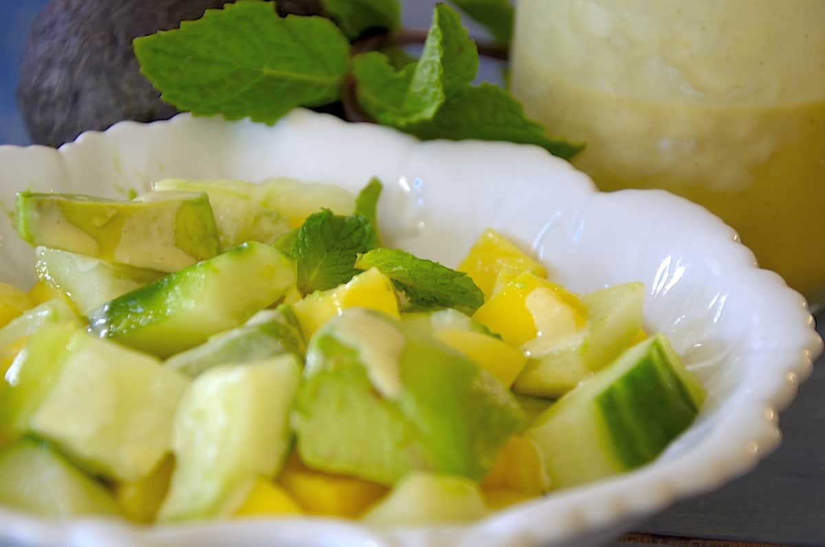 Chopped avocado, mango and cucumber in a salad bow. 