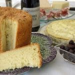 Tall loaf of Italian Easter bread with a wedge cut out of it.