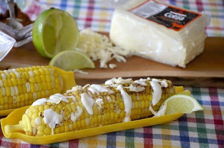Corn on the cob garnished with mexican spices, grated cheese and mexican crema.