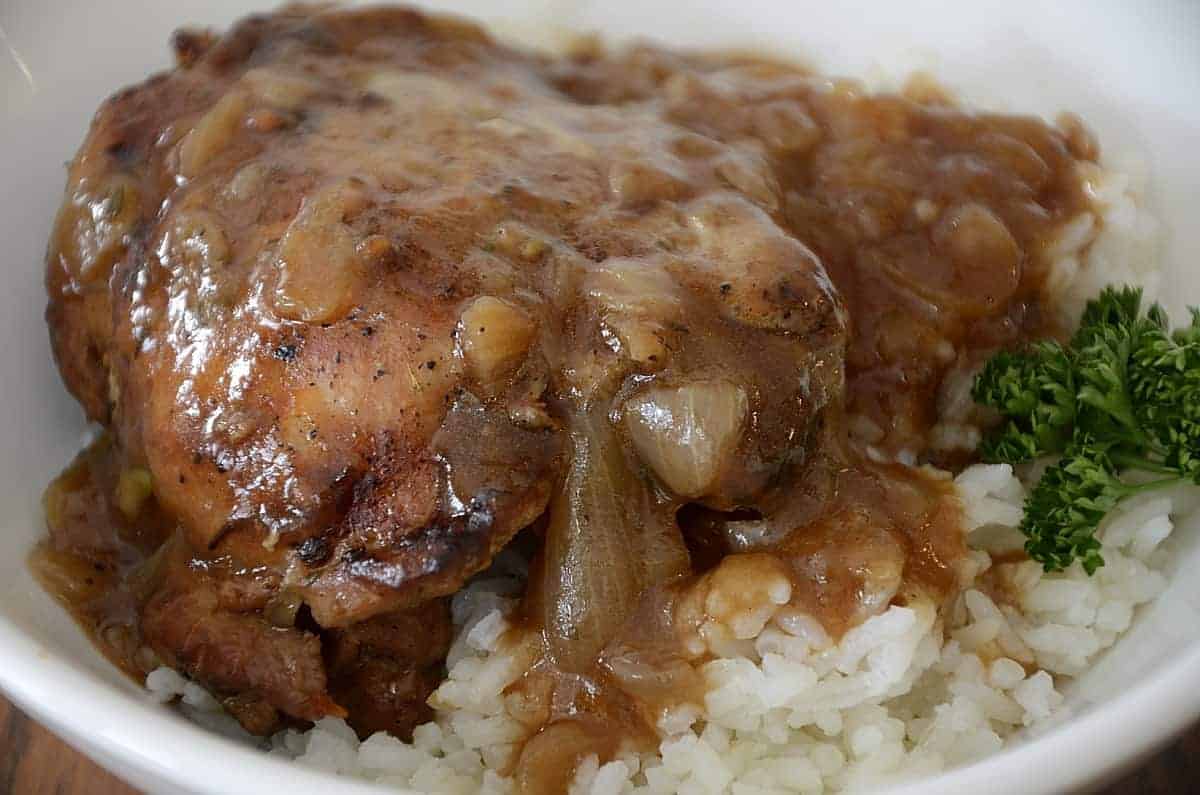 Chicken thigh in vinegar, onion sauce over rice.