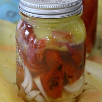 Roasted peppers with sliced onions in pint jars.