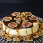 Creamy, cheesecake with balsamic caramel drizzled on top, garnished with fresh fig slices and candied walnuts.