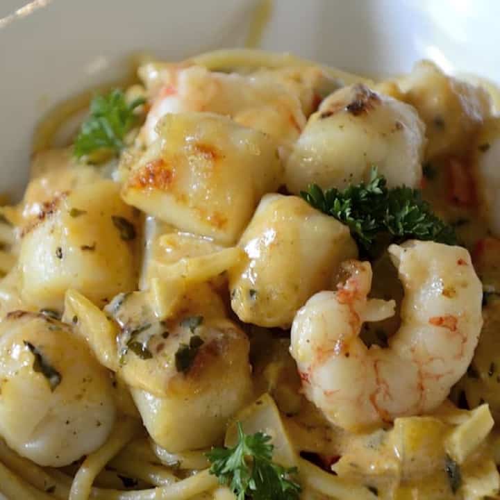 A decadent plate of Creamy Seafood Pasta with succulent shrimp and fresh herbs