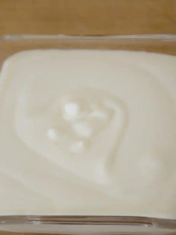 Creamy sour cream in a small dish.