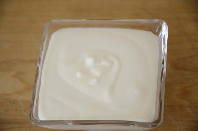 Creamy sour cream in a small dish.