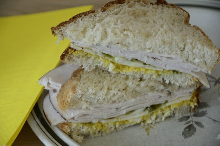 Turkey sandwich on sof airy buttermilk bread on a plate.