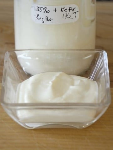 Thick creamy creme fraiche in a small dish.