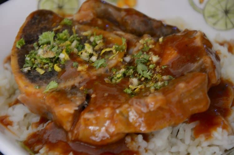 Close up of braised veal shank in tomato sauce with gremolata.