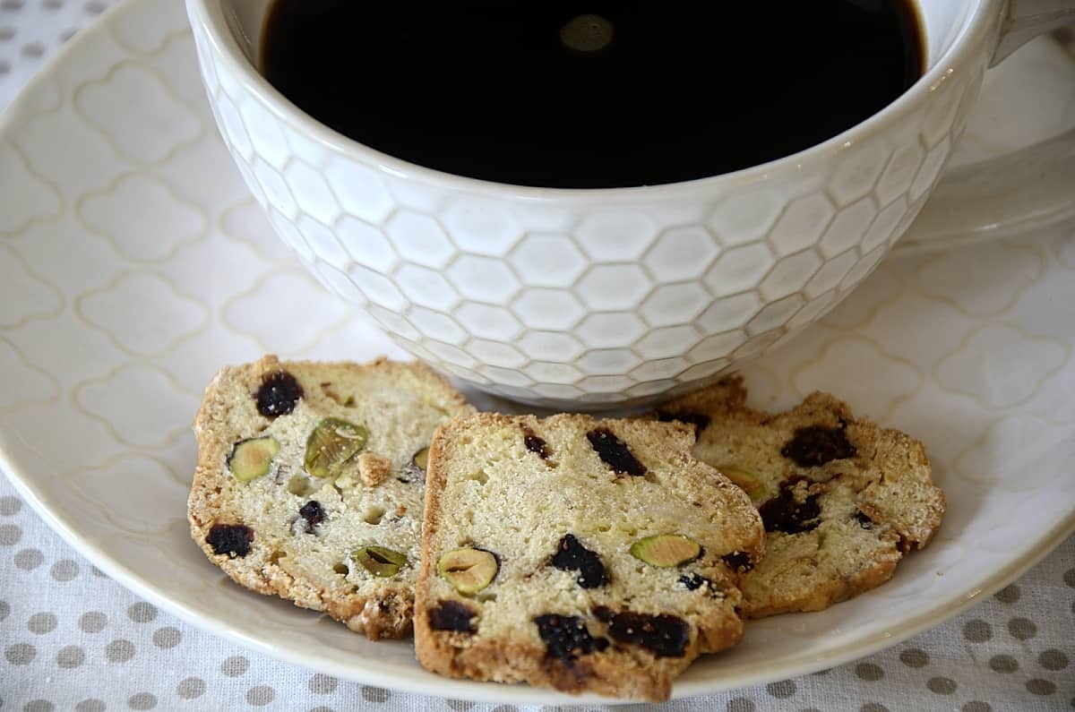 Thin sliced almond thinaddictives on a tray with a large cup of coffee