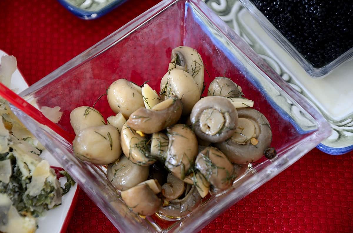 Marinated gourmet mushrooms in a cocktail dish.