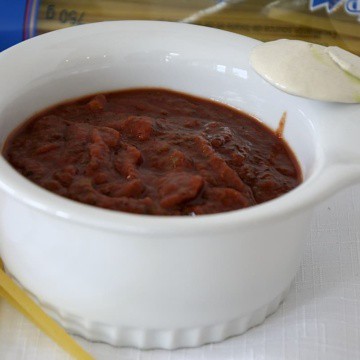 White Ceramic dish with thick deep red wine pasta sauce.