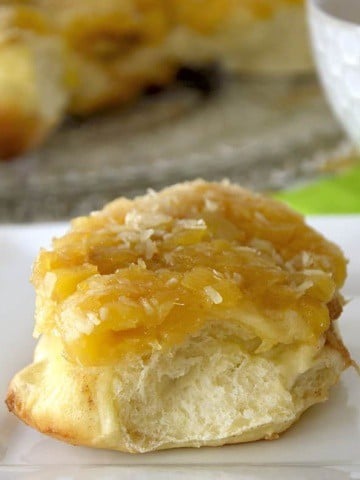 Pineapple cream cheese bun on a plate.