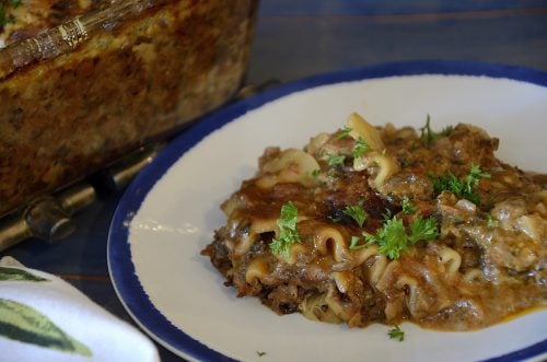 Ottolenghi lasagne on a plate garnished with parsley.