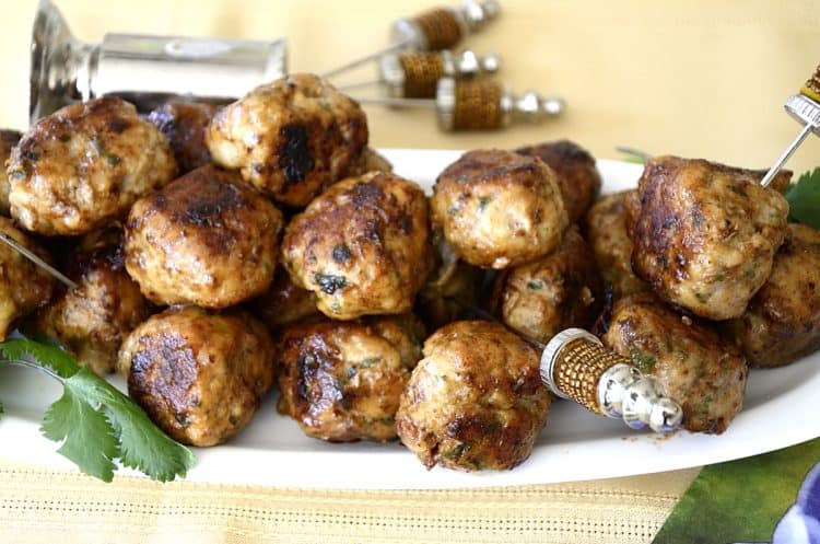 Crispy, browned lemon turkey meatballs on a platter with serving picks.