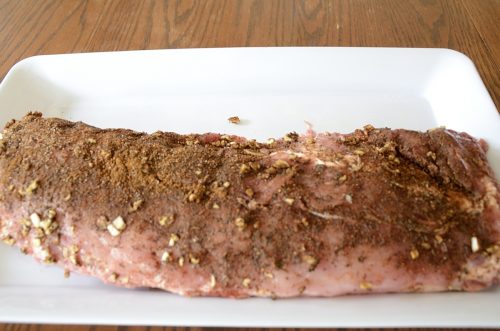 Slab of uncooked back ribs with dry rub.