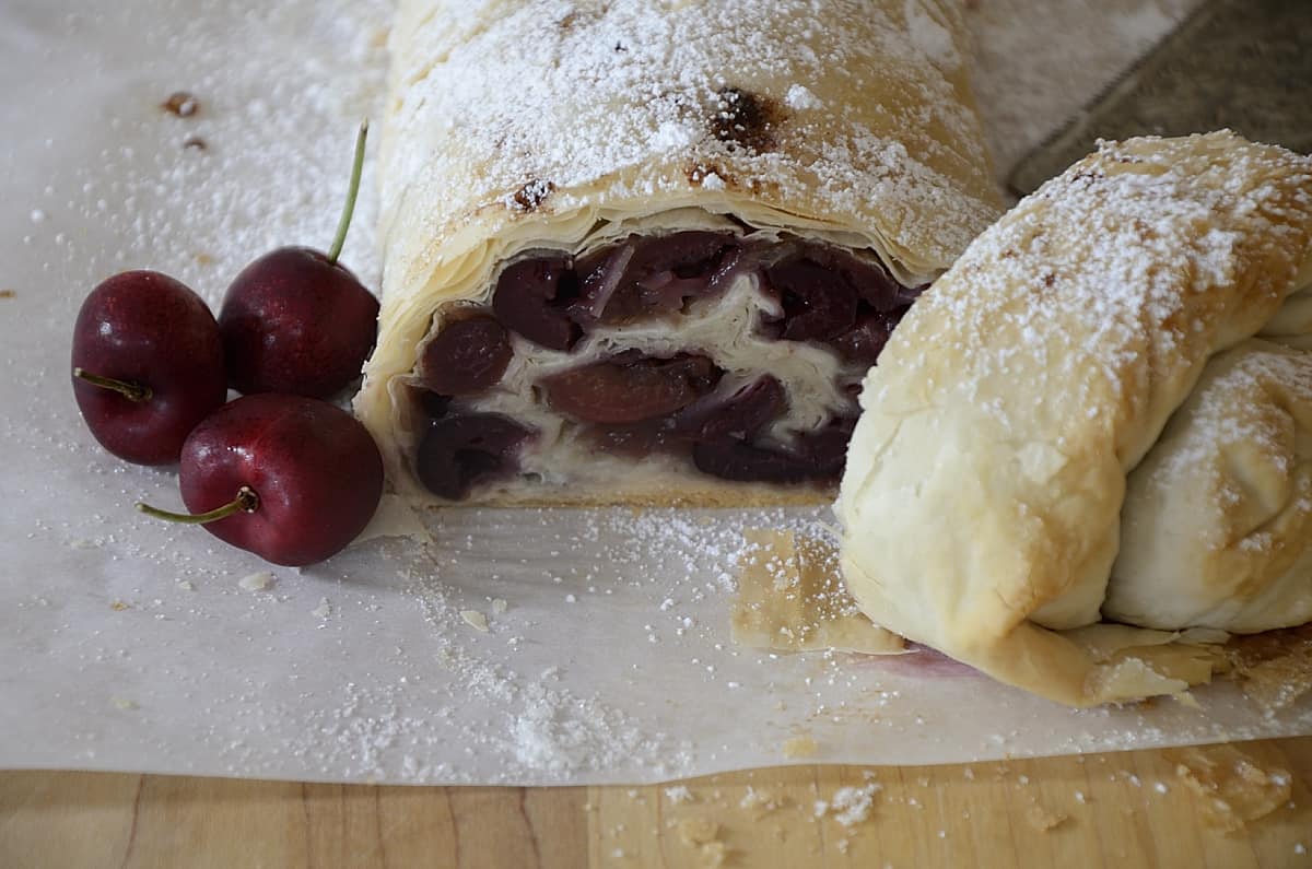 Cherry strudel sliced and dusted with icing sugar and a pinch of cinnamon.