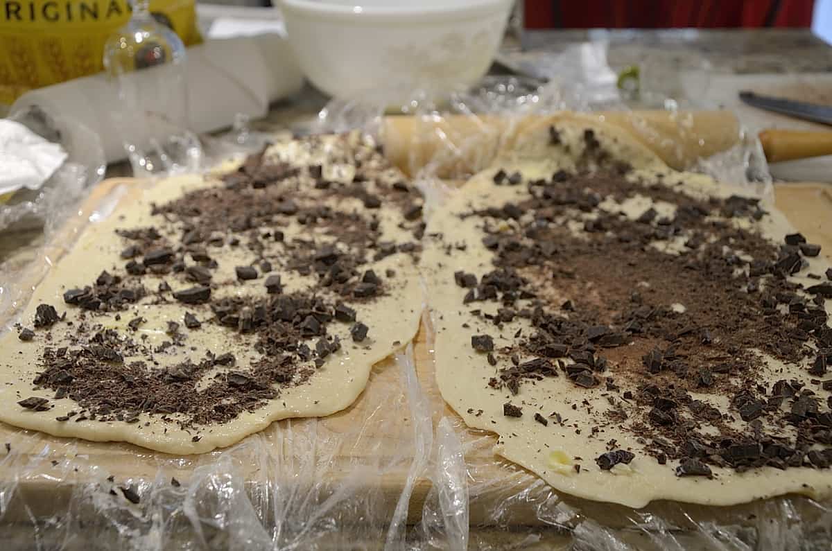 Dough rectangels for cruffins sprinkled with grated chocolate.