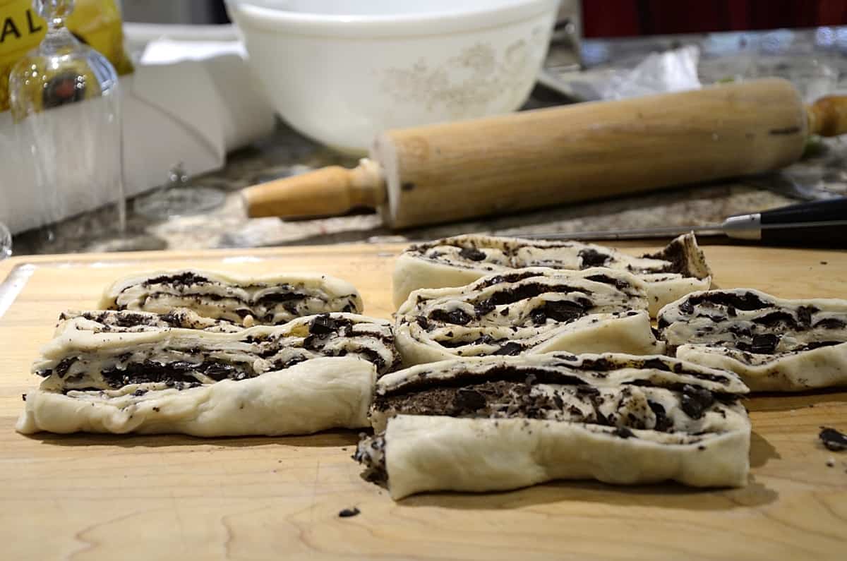 Cruffin dough logs cut open length-wise.