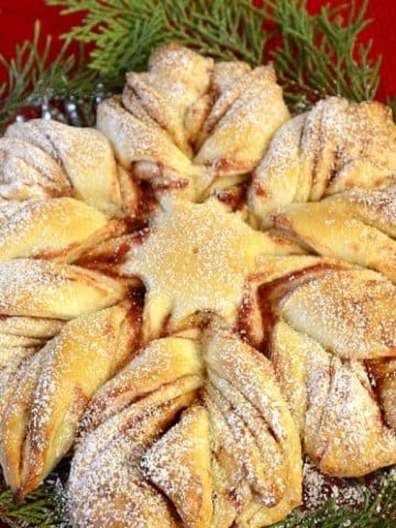 Baked Christmas Star bread on a bed of greenery.