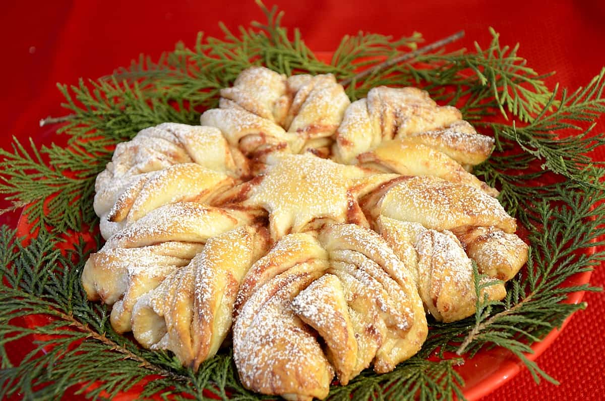 Baked Christmas Star bread on a bed of greenery.