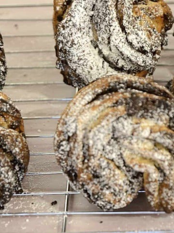 Chocolate cruffins-doughy pastry wound in to a muffin shape, filled with melted chocolate and dusted with icing sugar.