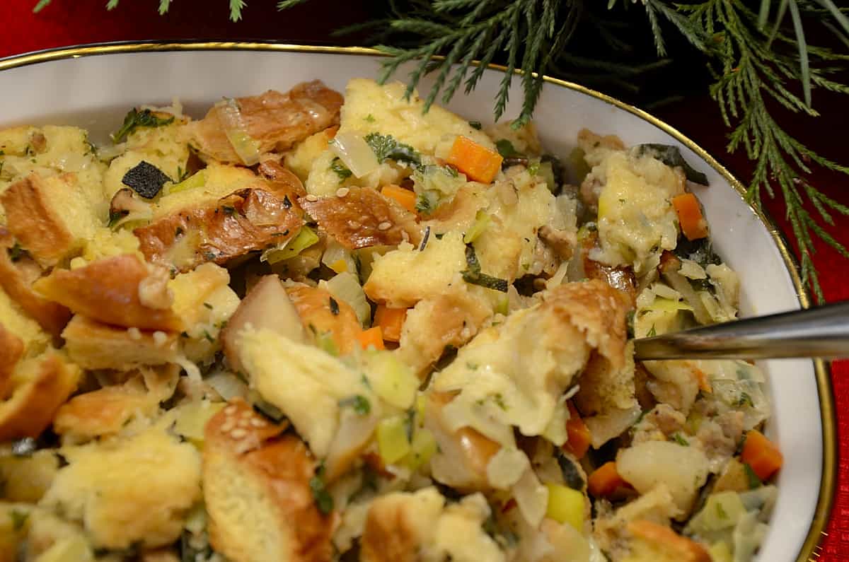 Brioche dressing in a serving dish with pears and honey garlic sausage.