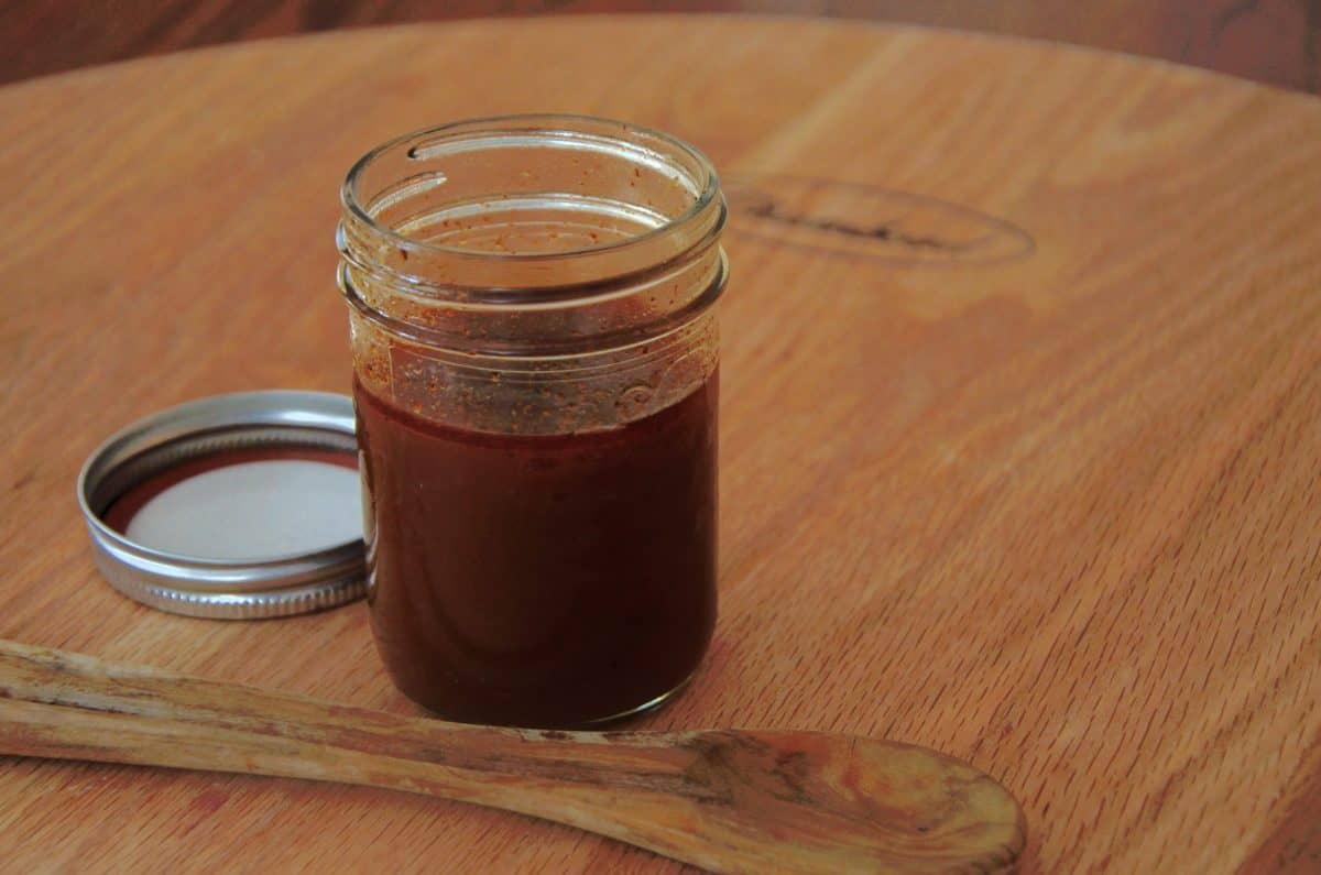 Mason jar of golden brown veal stock.