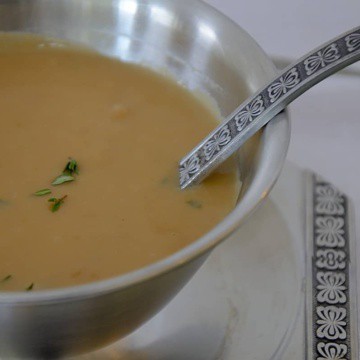 Creamy turkey Marsala gravy in a dish with small ladle.