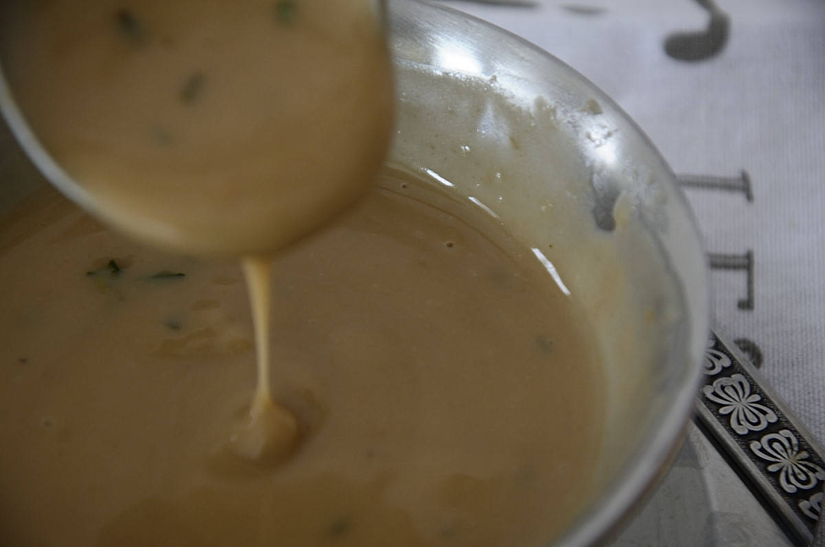 Creamy Turkey Marsala Gravy dripping off a gravy ladle.