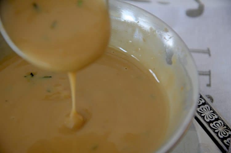 Creamy Turkey Marsala Gravy dripping off a gravy ladle.