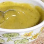 Golden yellow honey mustard dressing in a small container.