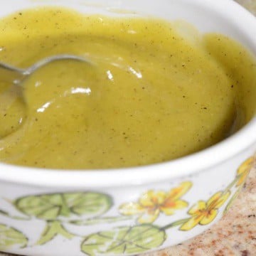 Golden yellow honey mustard dressing in a small container.