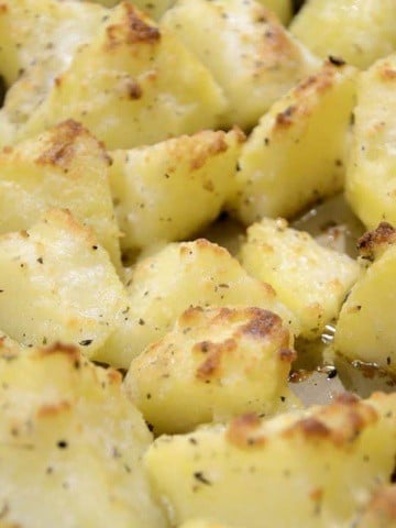 Golden, crispy potato quarters coated in garlic and parmesan butter.