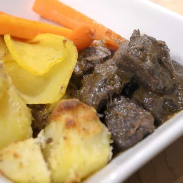 Garlic Parmesan Roast potatoes in a dish wich Red wine braised beef and roasted carrots.