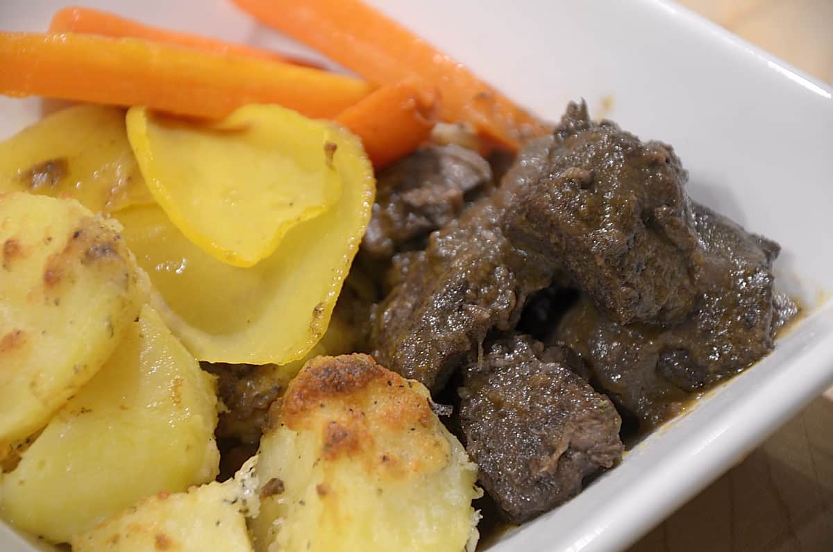 Garlic Parmesan Roast potatoes in a dish wich Red wine braised beef and roasted carrots.