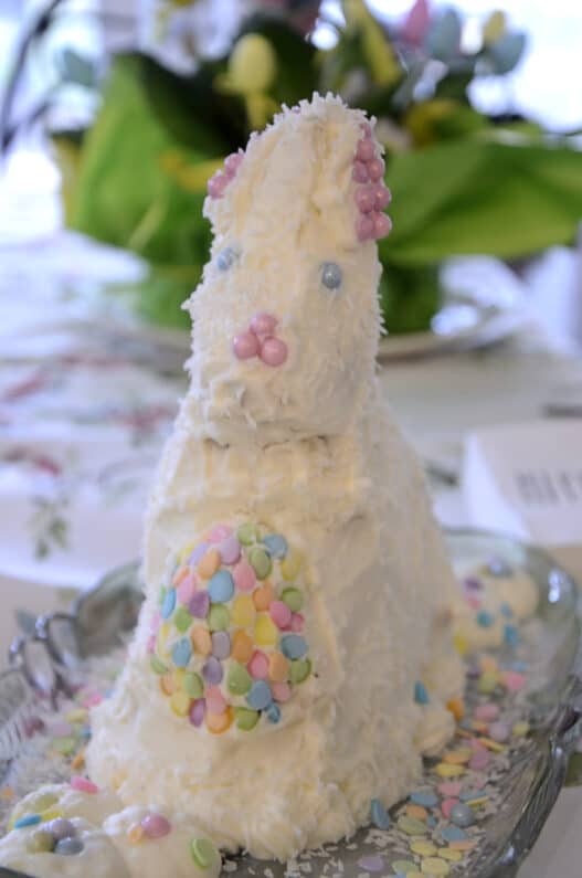 Easter bunny carrot cake decorated with cream cheese frosting and sprinkles.