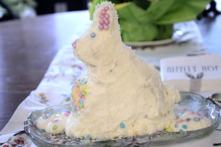 Easter bunny carrot cake decorated with cream cheese frosting and sprinkles.