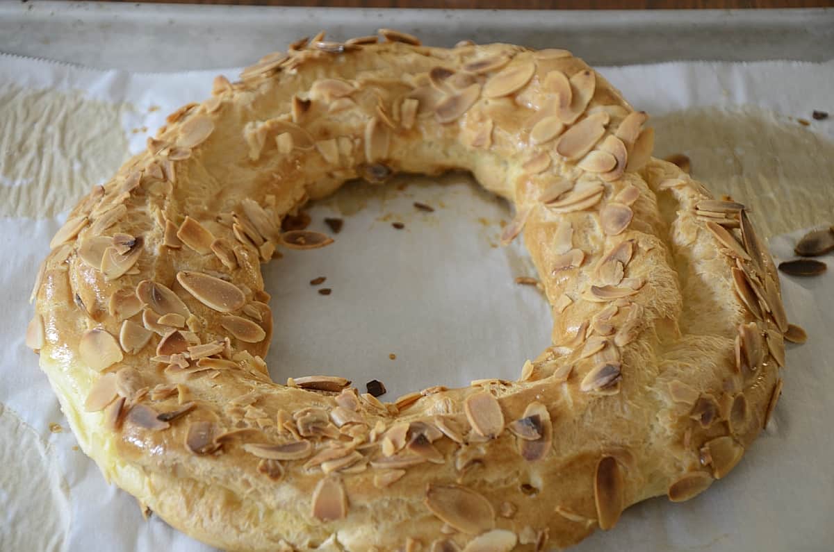 Paris-Brest Pastry Ring filled with pastry cream and garnished with praline and toasted almonds.