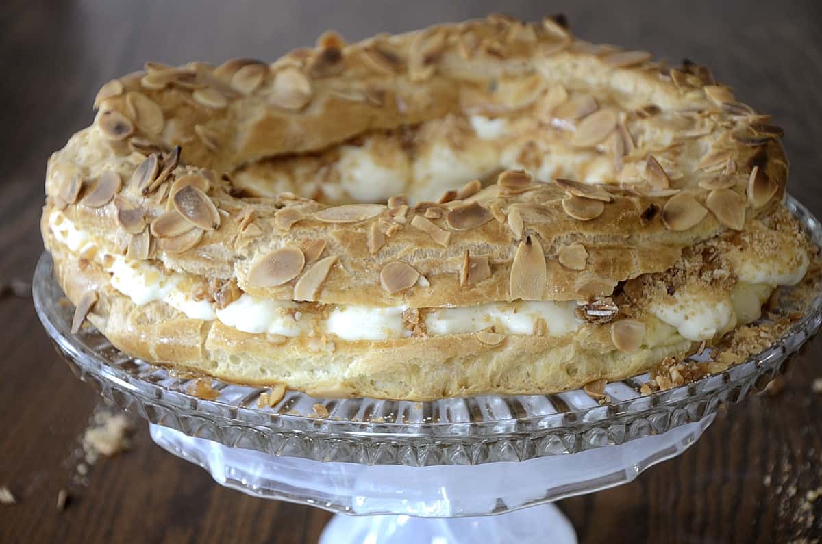 Paris-Brest Pastry Ring filled with pastry cream and garnished with praline and toasted almonds.