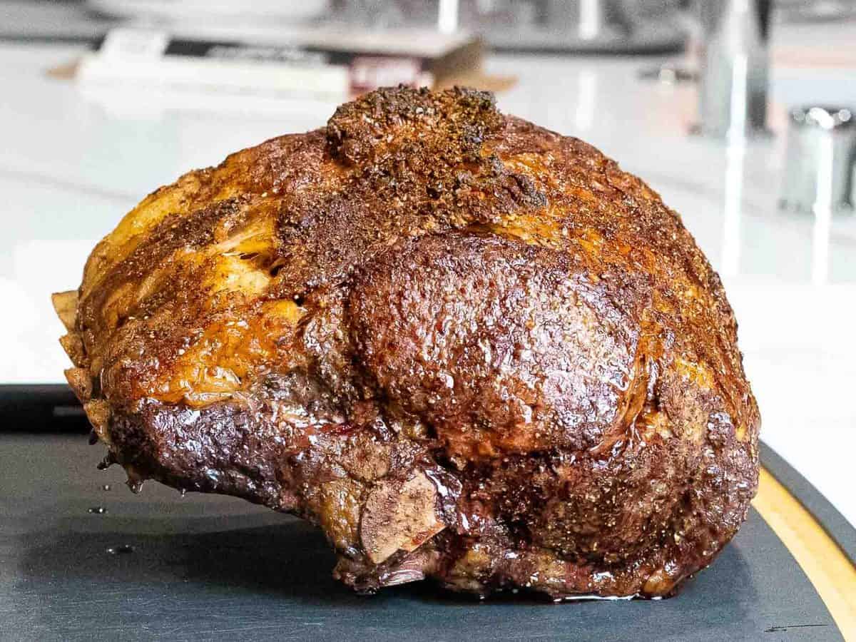 Crusted, seasoned prime rib roast out of the oven.